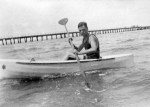 Harold Beatty paddling a boat beside Mentone Pier c. 1925