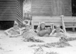 Harold and Peggy Beatty; Winifred and Graeme Blair outside bathing huts on Mentone beach, Victoria c. 1925